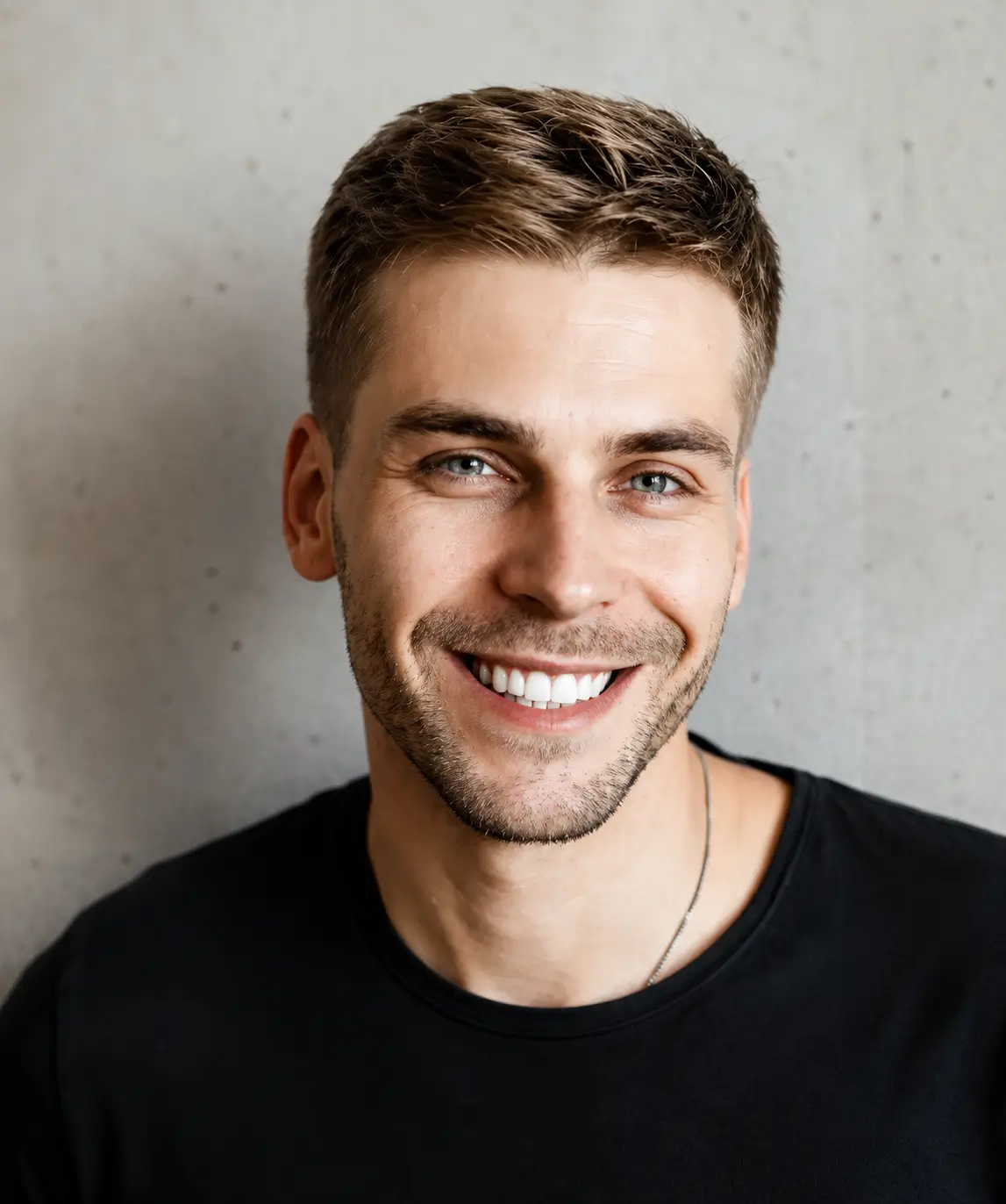 Man smiling confidently after cosmetic dentistry treatment