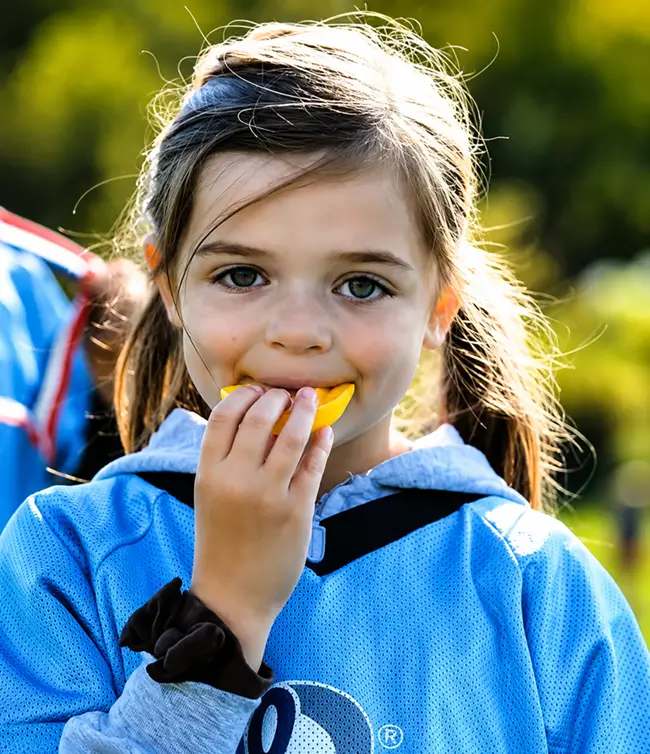 Child wearing a custom mouthguard