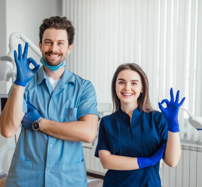 clinical staff in scrubs making ok sign