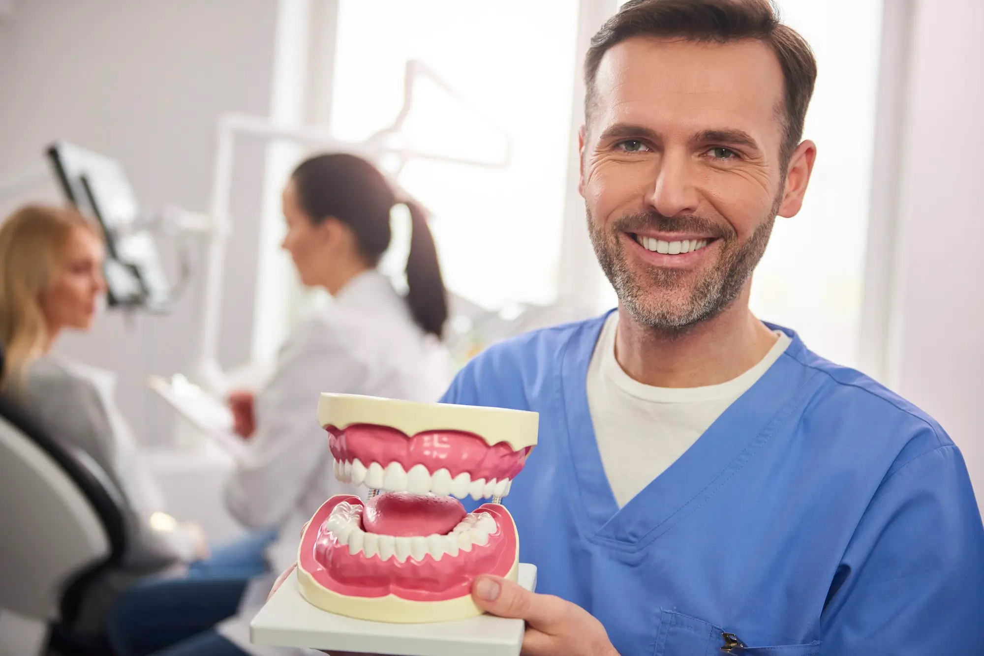 Clinician holding a dental model in a dental clinic