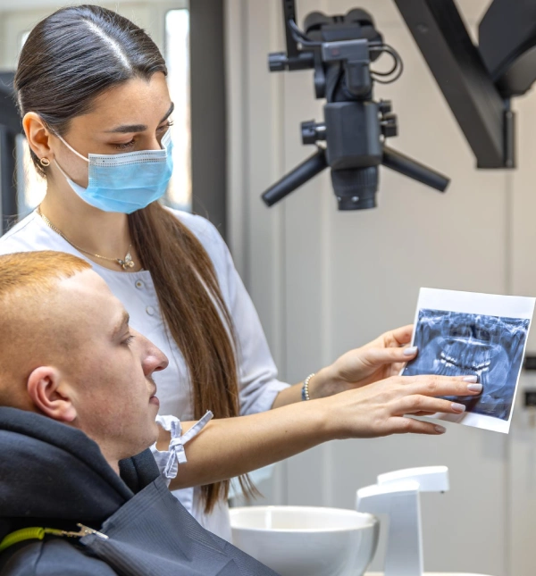 clinician-showing-panoramic-dental-xray-to-ma