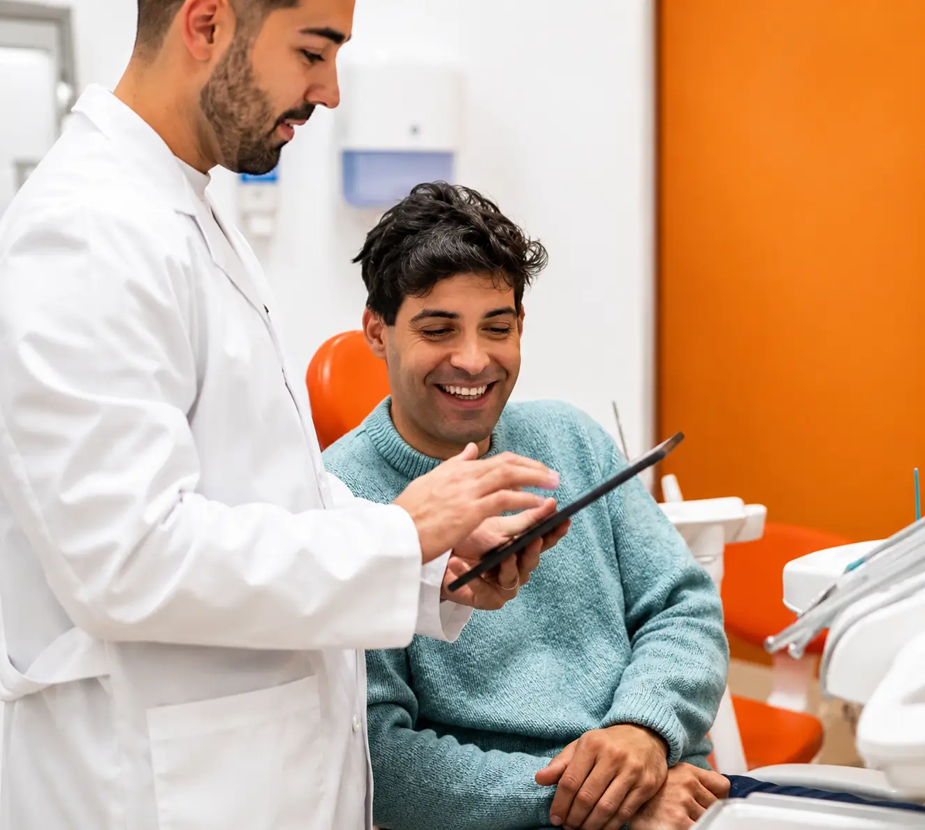 Clinician showing a tablet to a seated person
