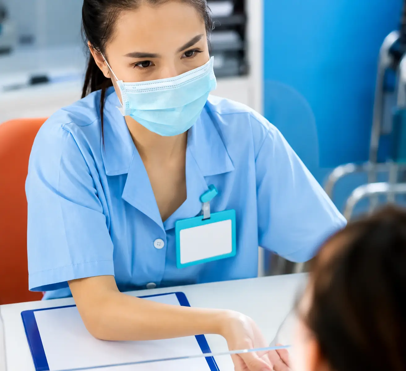 Clinician speaking with a person across a desk