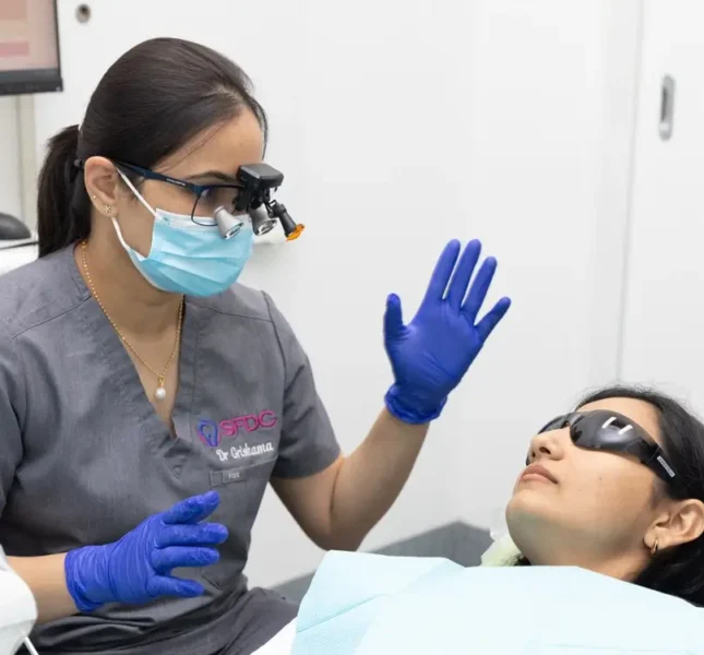 Clinician speaking with person dental chair