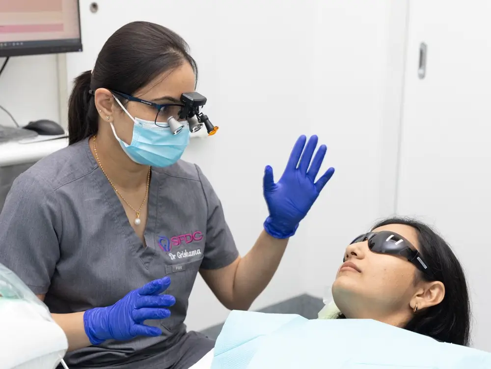 Clinician speaking with person dental chair