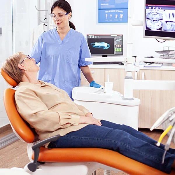 clinician speaking with woman in treatment chair