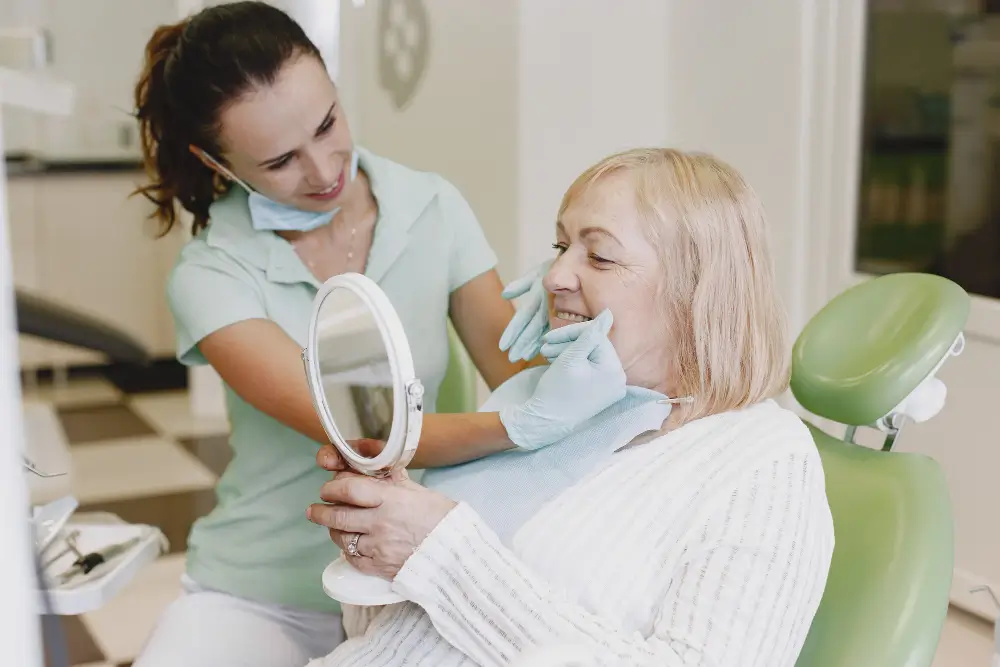 Clinician reviewing the fit of custom dentures with a patient