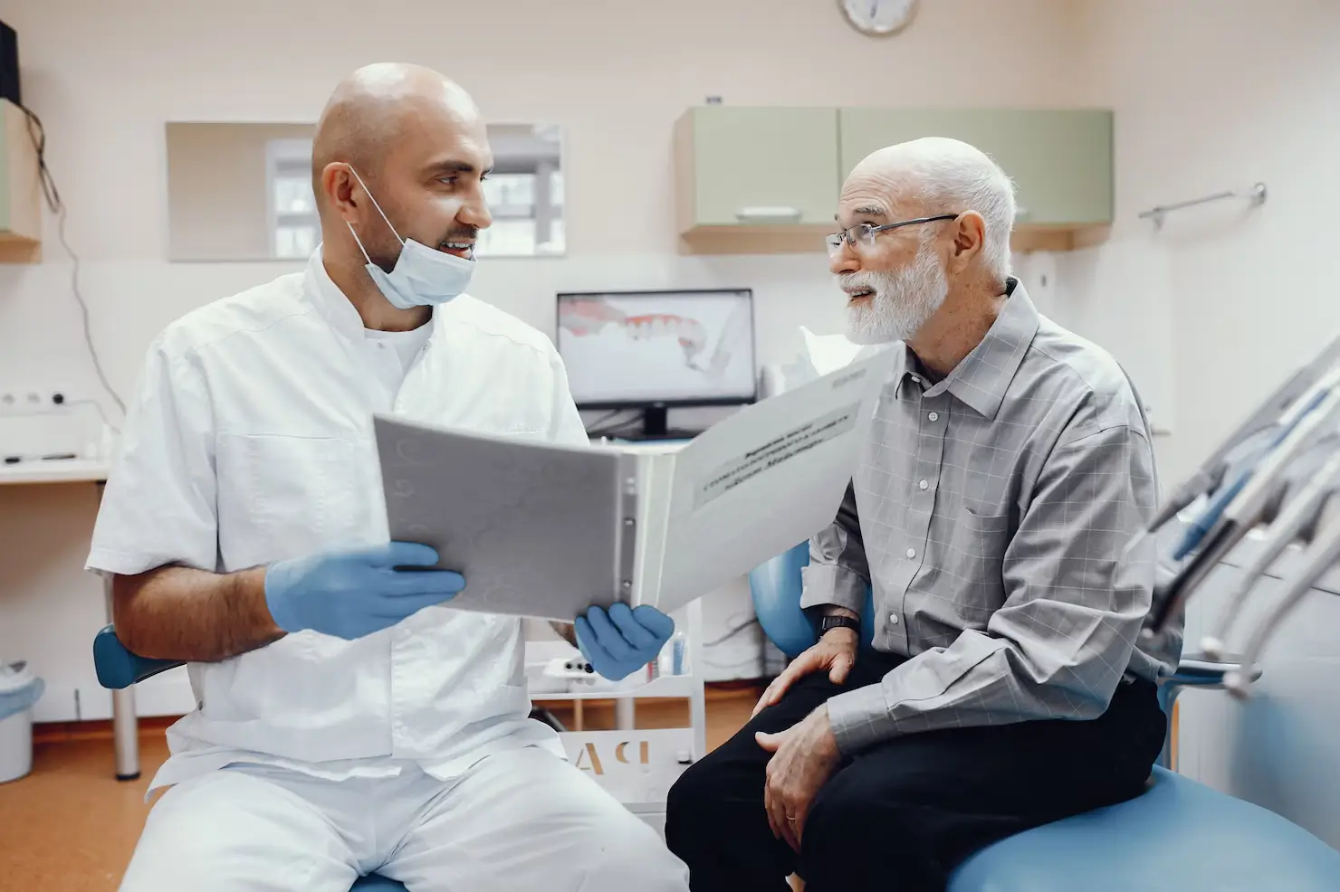 Clinician discussing custom denture treatment with a patient