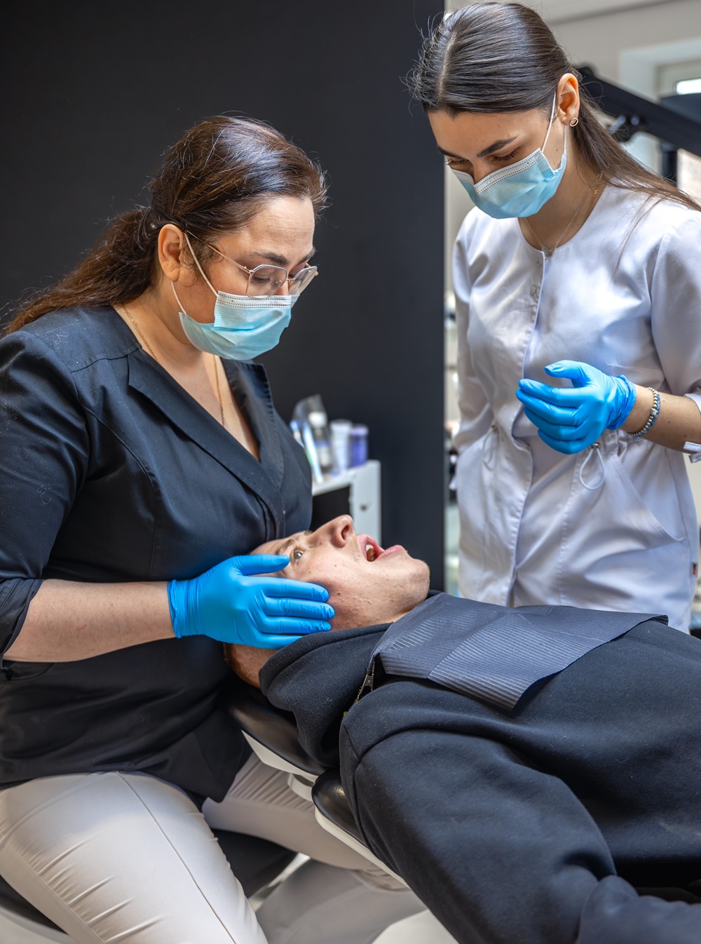 Dentist examining a patient's teeth during a comprehensive dental consultation