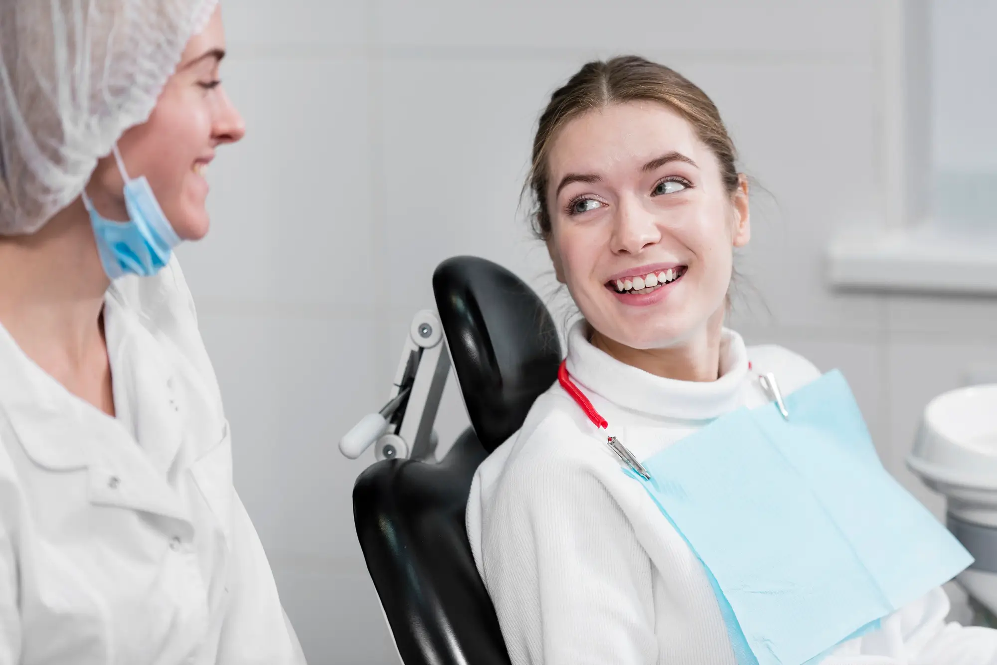 Dentist talking with a smiling patient before dental treatment