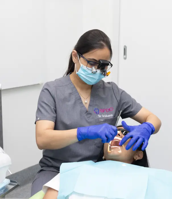 Dentist performing a dental procedure while ensuring patient comfort during treatment