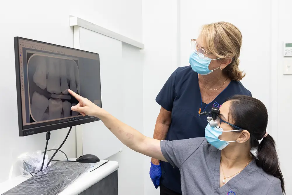 Dentists reviewing a patient's dental X-ray to plan treatment