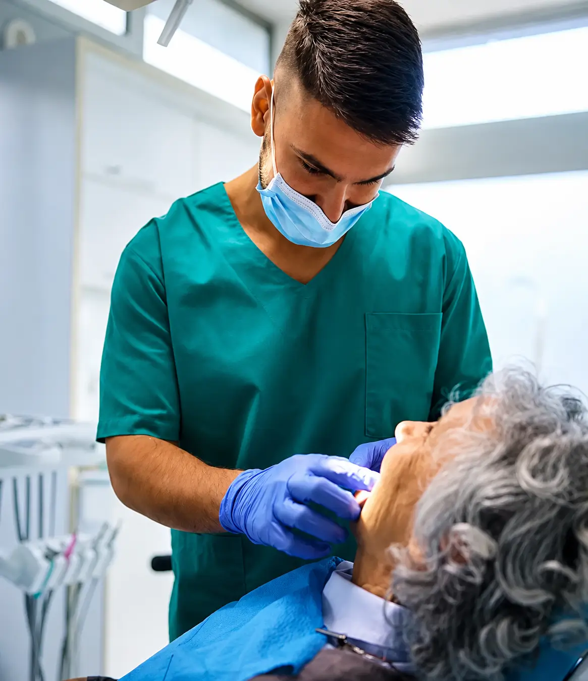 Clinician examining a patient during a denture consultation