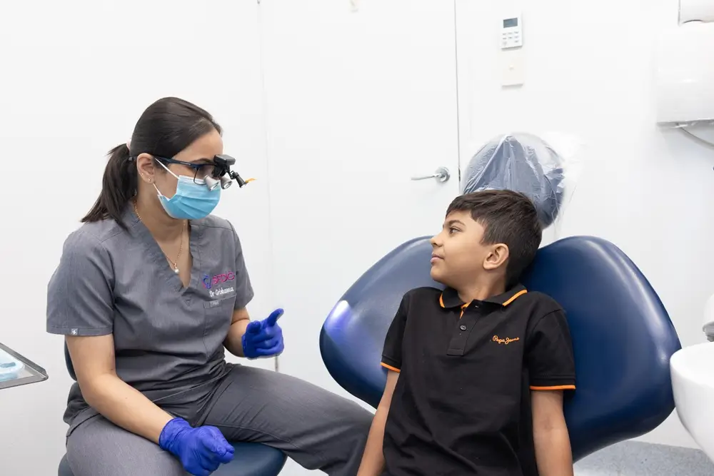 Dr Grishma speaking with a child before a dental examination at Southside Friendly Dental Care