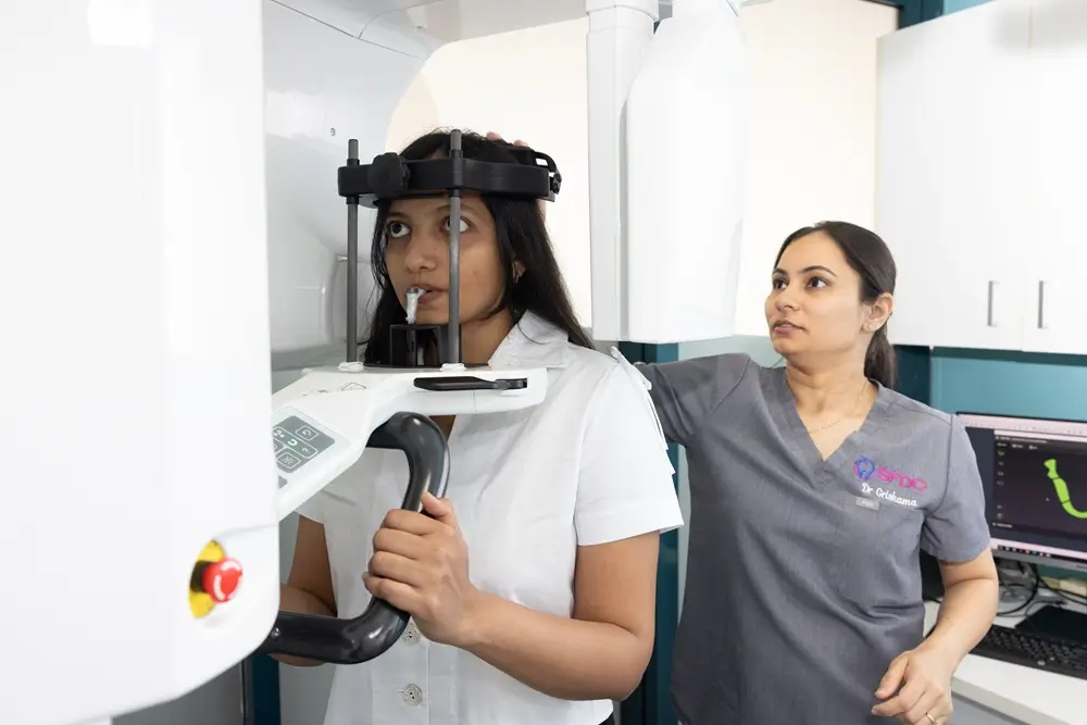 Dr Grishma assisting a patient during a dental CBCT scan