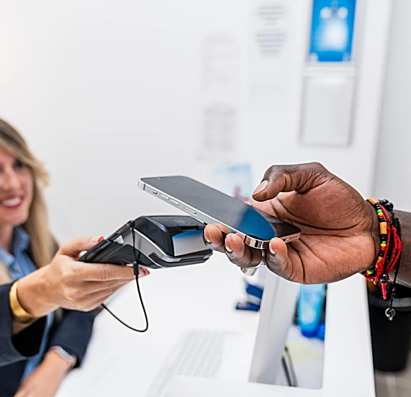 patient holding mobile pay for dental treatment