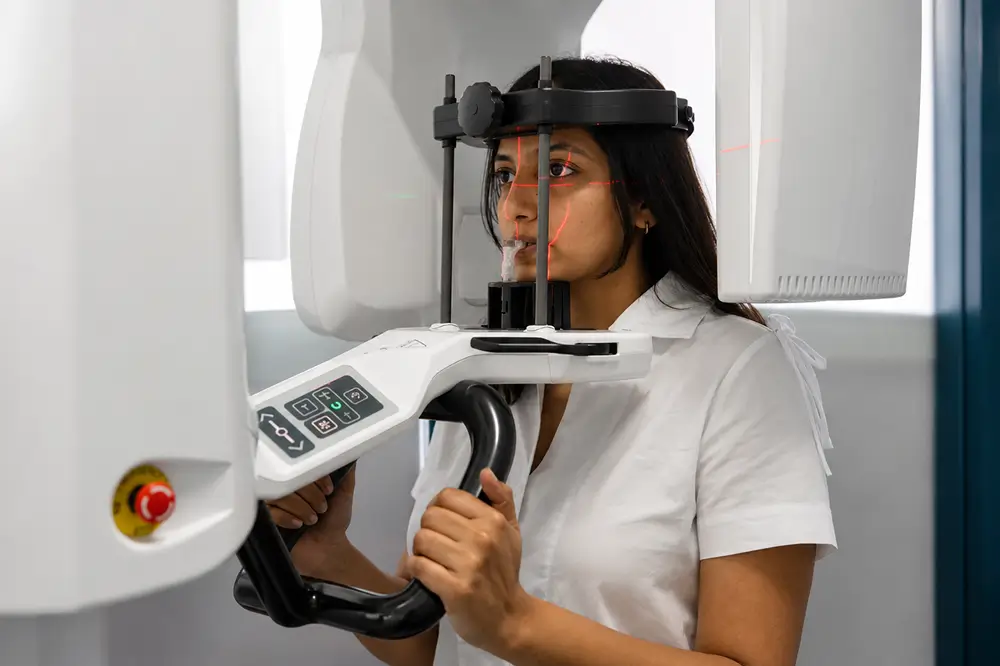 Patient undergoing a 3D CBCT dental scan for treatment planning