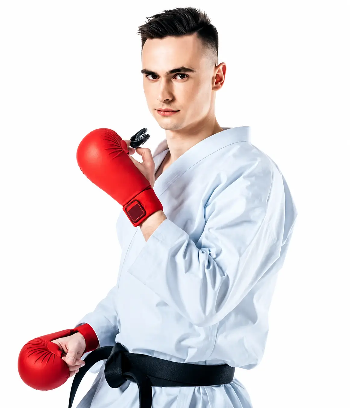 Person wearing a white martial arts uniform and red boxing gloves
