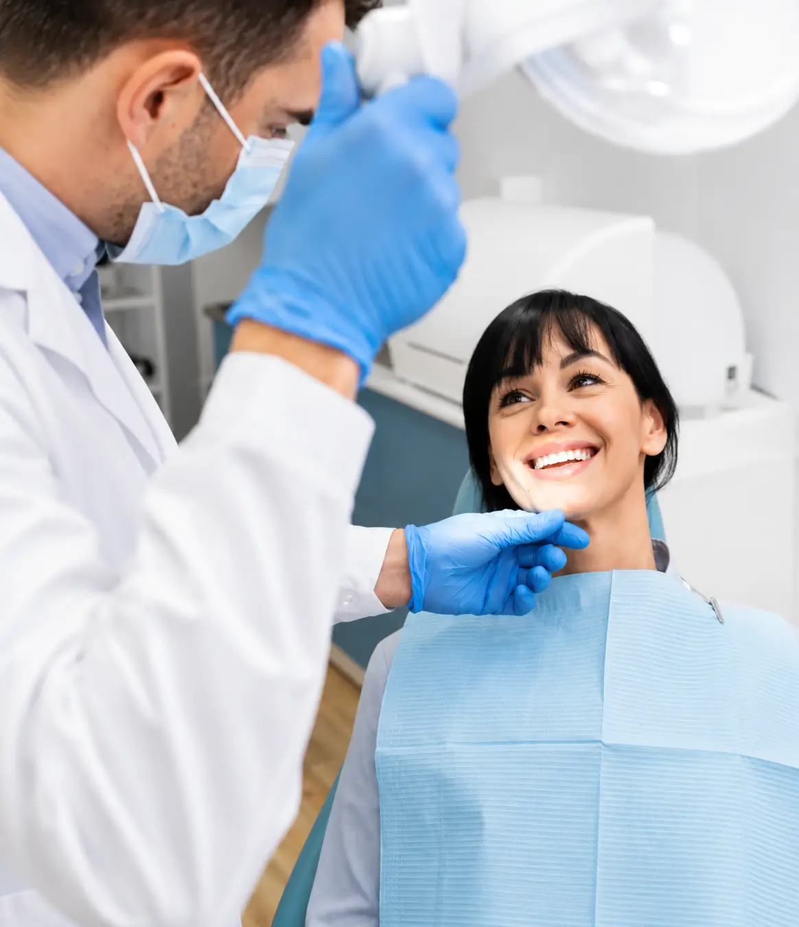 Dentist examining a patient's teeth during a routine dental check-up