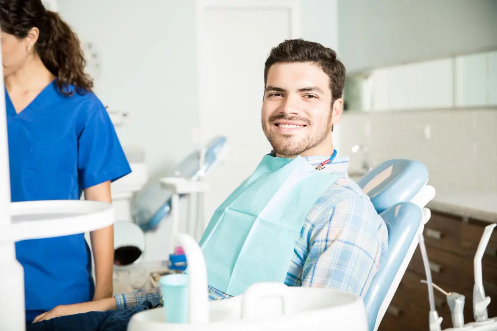 Patient smiling during a routine dental check-up at the dental clinic