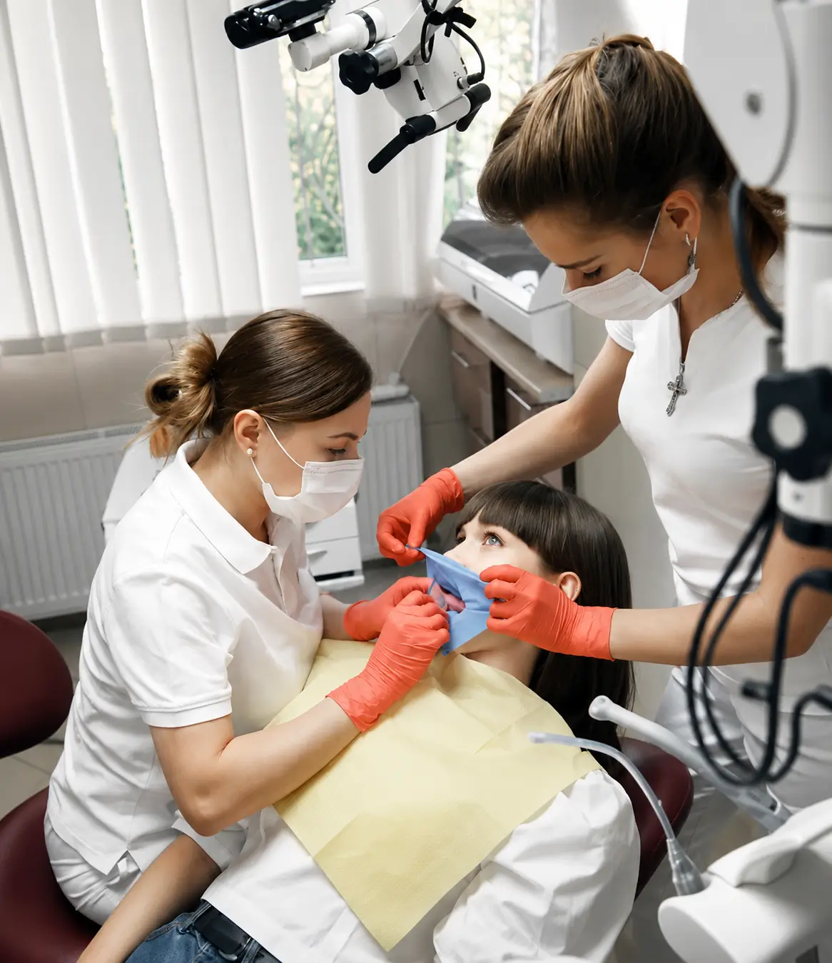 Dental team performing a smile makeover treatment to improve the appearance and function of a patient's smile