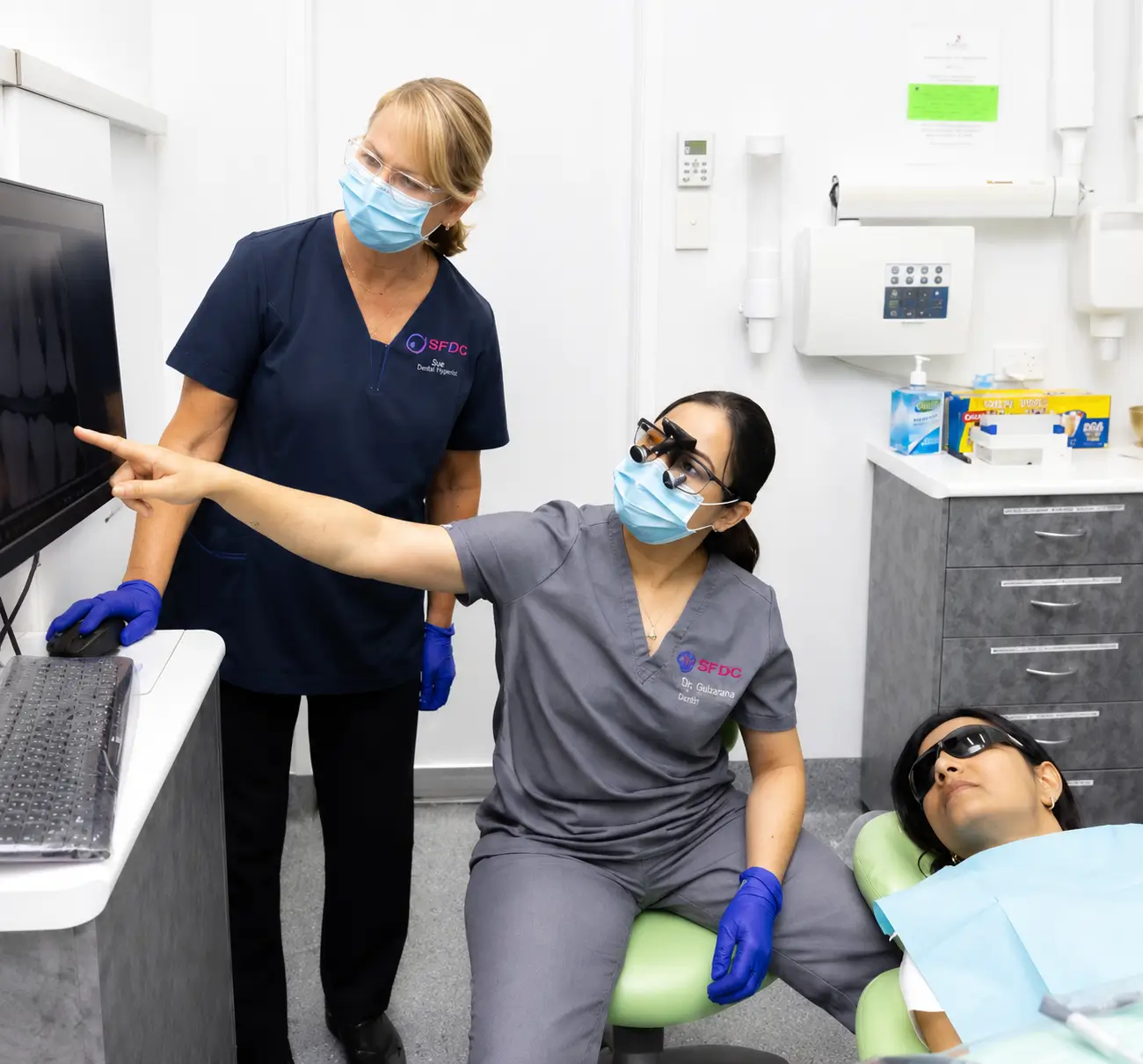 Southside Friendly Dental Care team members reviewing a dental scan with a patient