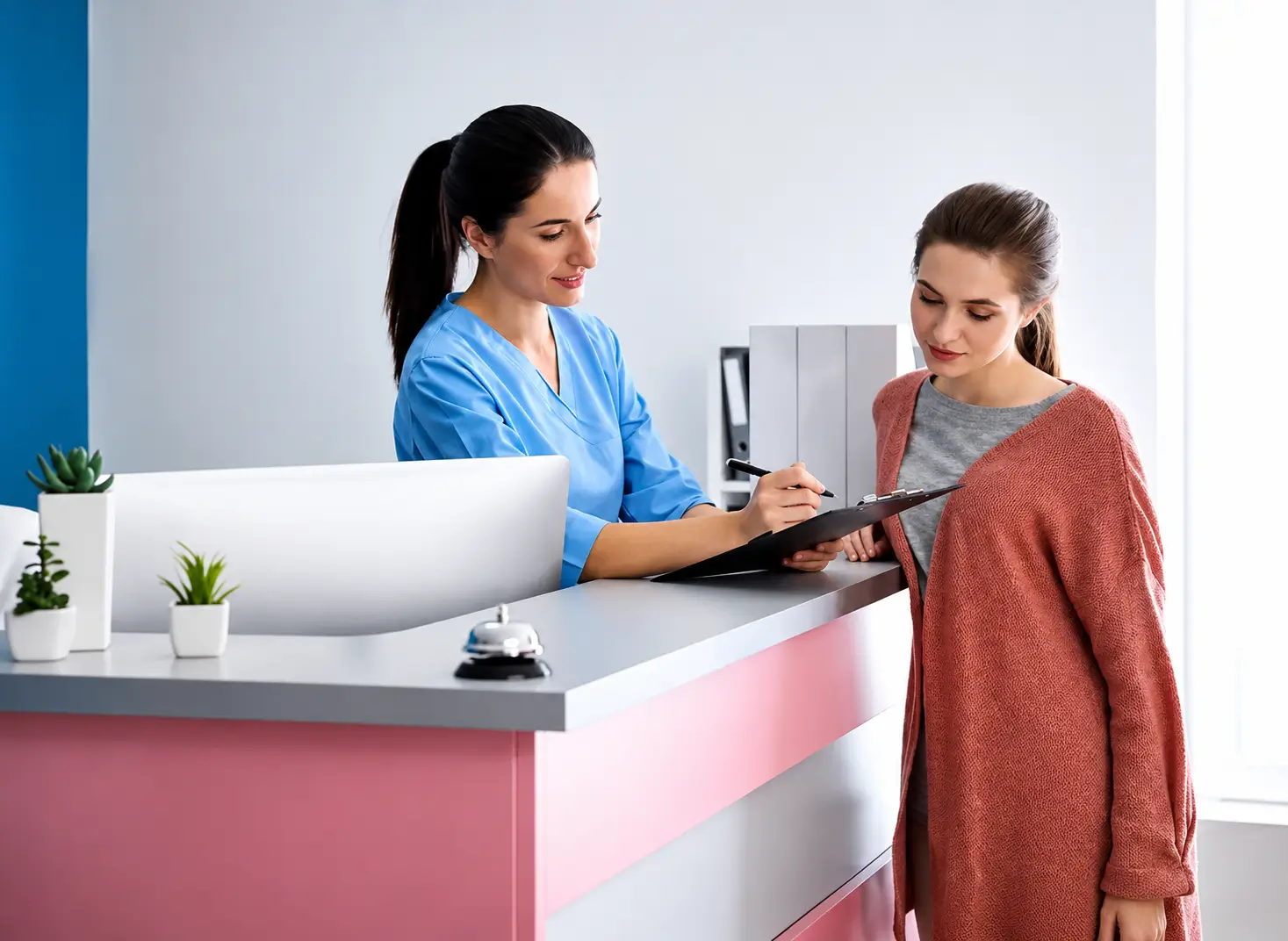 Staff member reviewing a form with a person at a reception desk