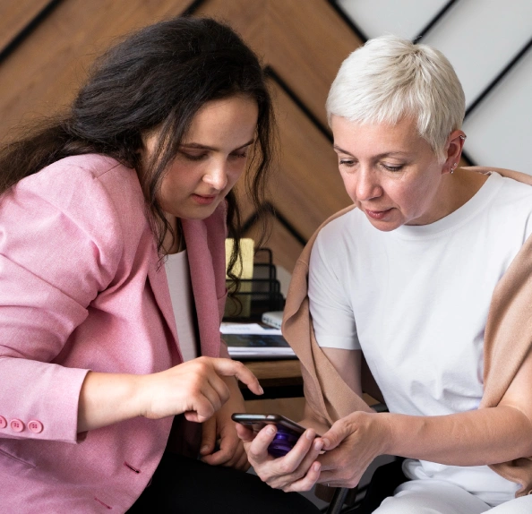 woman pointing to smartphone screen