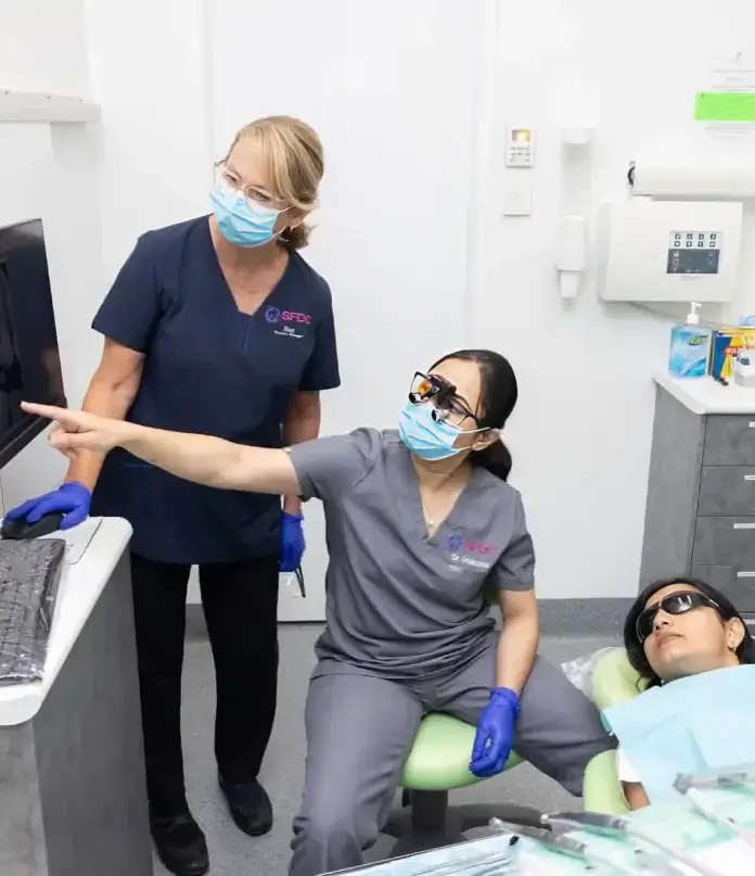 Dentist explaining treatment plan to patient using digital dental images
