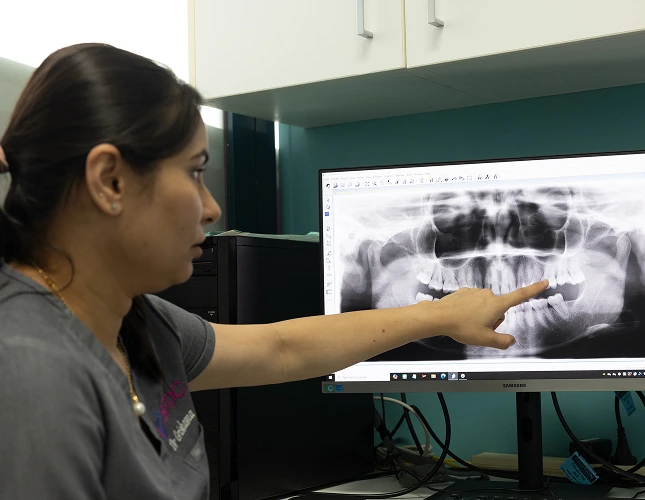 dentist pointing panoramic dental xray