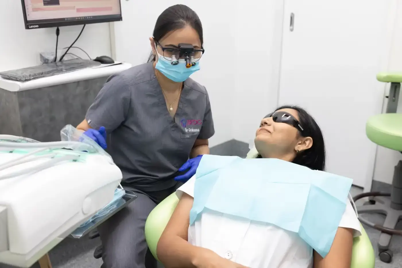 Dentist preparing a patient for dental treatment in the clinic.