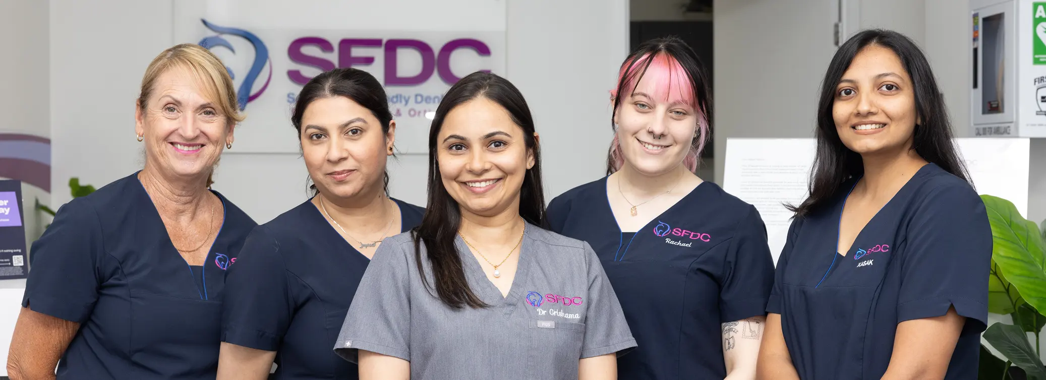 Friendly dental care team smiling together at SFDC dental clinic