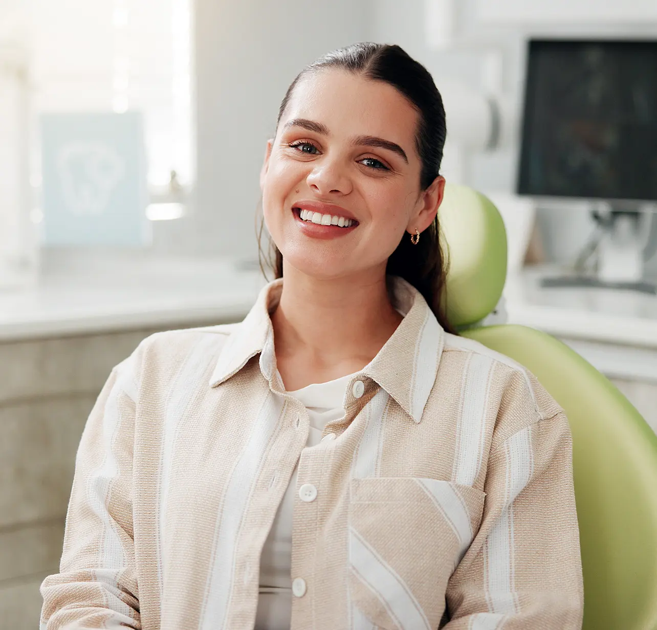 Smiling woman sitting comfortably in a dental chair